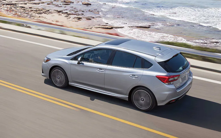 A 2022 Impreza 5-door driving down a highway.