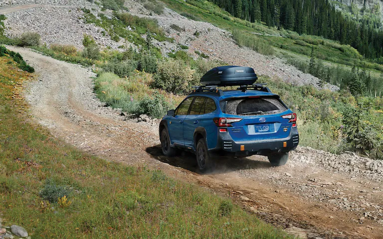 2022 Outback Wilderness driving down a rocky incline.